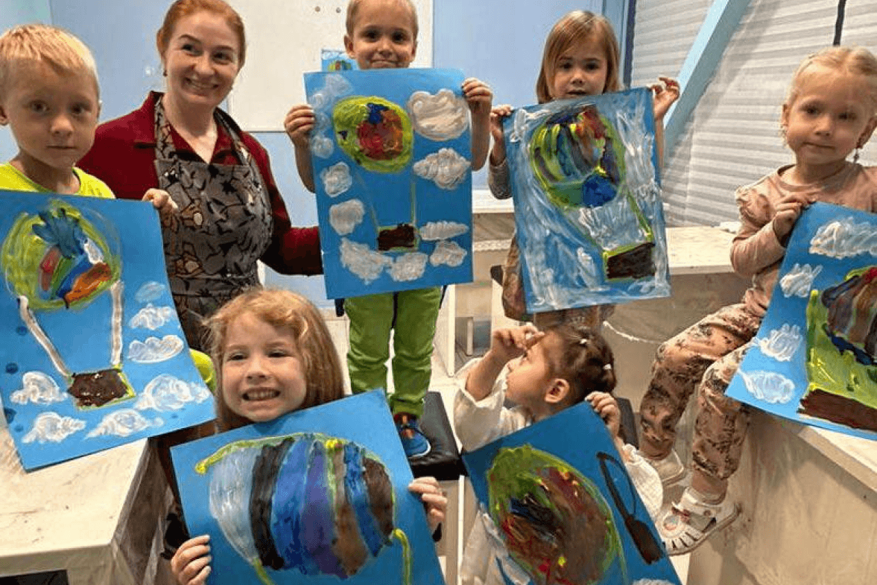 Preschool teacher working with a small group of children
